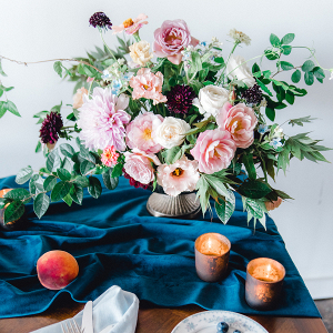 Lush wedding tablescape with velvet linens and pink centerpiece