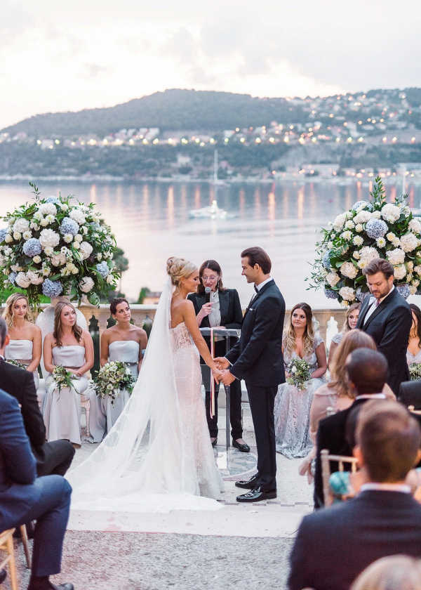 Glam waterside terrace wedding ceremony