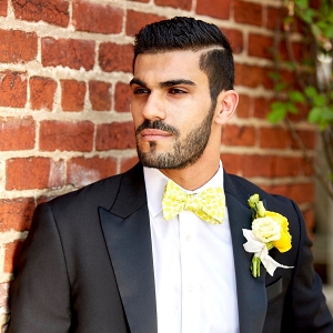 Groom in Black Tuxedo with Yellow Bow-Tie and Boutonniere
