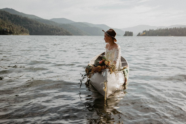 Boho bride in canoe