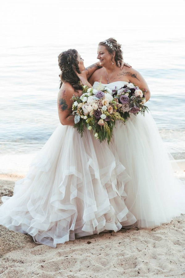Two brides at waterside wedding