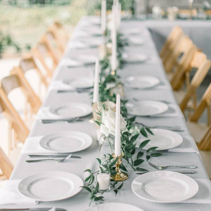 Minimalist taper candle and greenery centerpiece