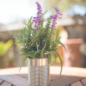 Handpicked floral and herb centerpieces in aluminum cans