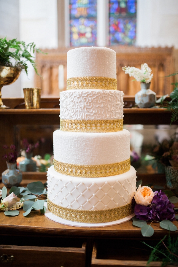 Four Tiered White and Gold Wedding Cake
