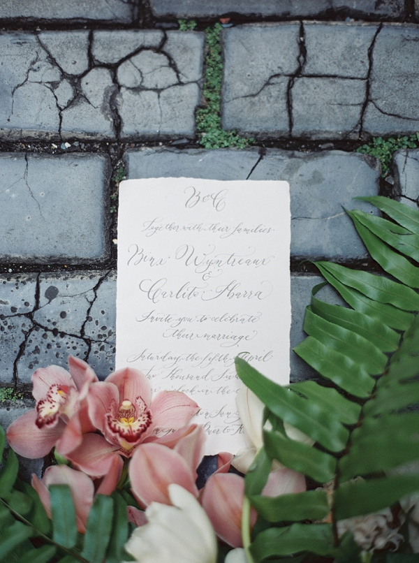 Calligraphy on a Wedding Invitation Surrounded by Flowers