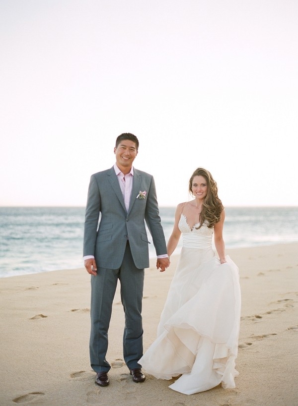 A Bride and Groom Holding Hands on the Beach