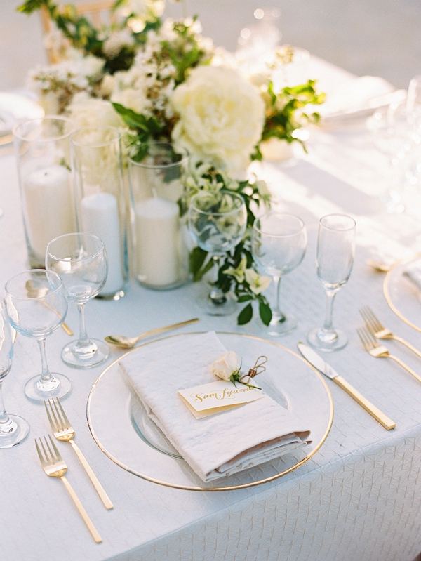 All White Place Setting With Flowers and Candles