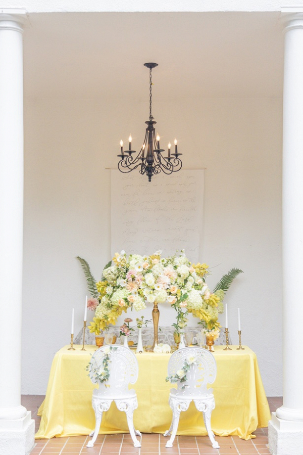 Yellow and peach wedding table with oversized floral centerpiece