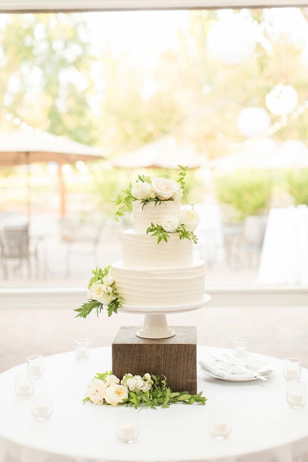 Classic white buttercream wedding cake with fresh flowers