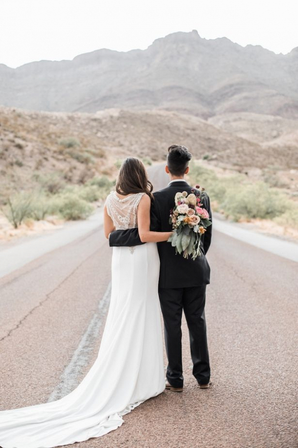 Bride and groom on desert road