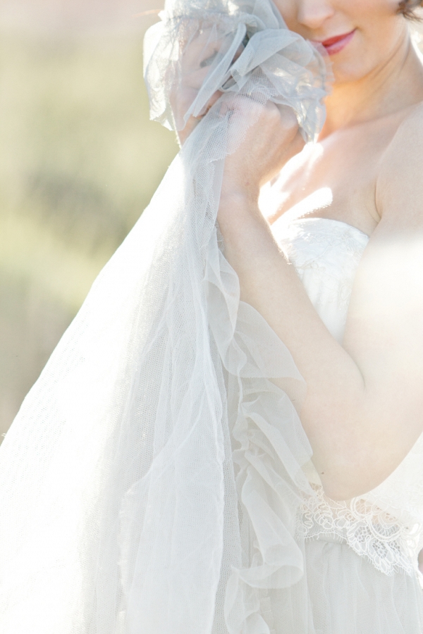 chantalle holds the layers of tulle from her beautiful dress against her cheek