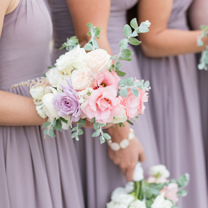 Beautiful bridesmaids wearing lilac and holding lovely little bouquets