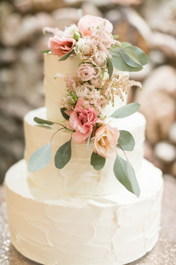 Jennie + Casey's beautiful tiered wedding cake adorned with flowers