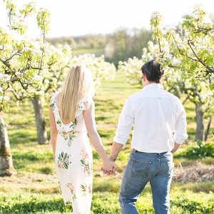 Viv and Jamie's engagement session in an orchard of blossoms