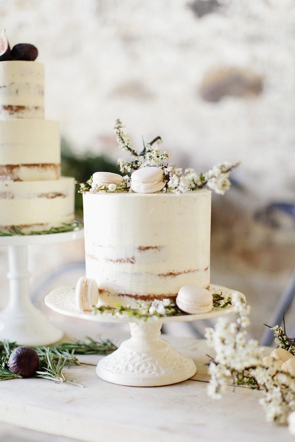 Elegant and Rustic Semi Naked Cake with White Spring Blossom and Vanilla Macarons