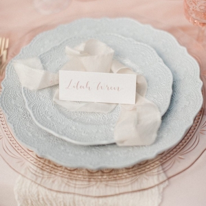 ribbons and calligraphy place card create a place setting with beautiful tableware