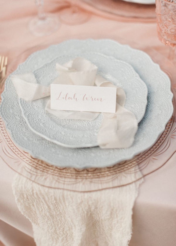 ribbons and calligraphy place card create a place setting with beautiful tableware