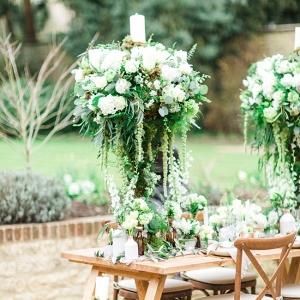 Organic Tablescape with Tall Centrepieces with Trailing Foliage and White Roses