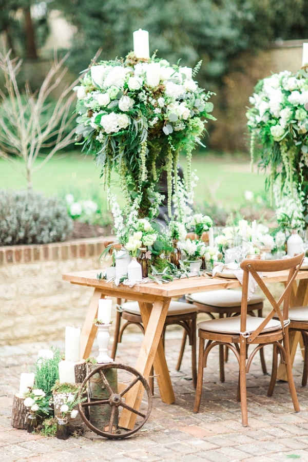 Organic Tablescape with Tall Centrepieces with Trailing Foliage and White Roses