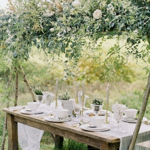 outdoor tablescape setting under floral canopy