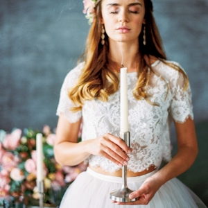 bridal portrait holding a tall tapered candlestick