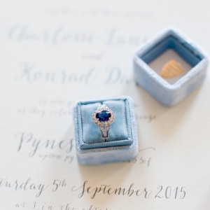 Vintage blue sapphire engagement ring in a blue velvet ring box with calligraphy stationery