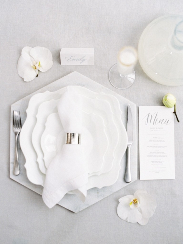 place setting display with orchid flowers and stationery
