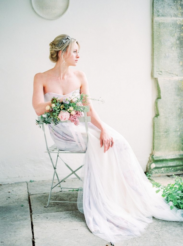bride sat on a chair decorated with flowers