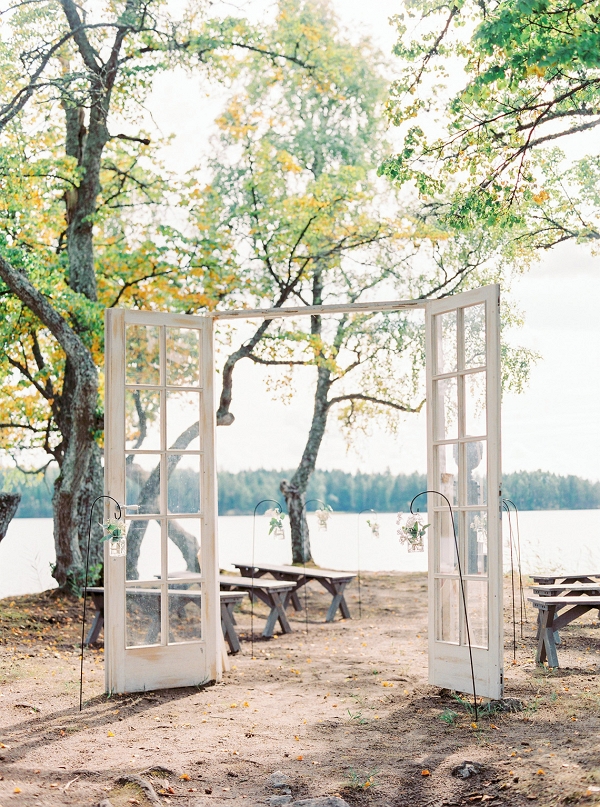 lakeside ceremony outdoors with statement door frame