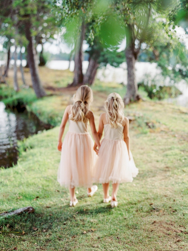 flower girls wearing pink holding hands