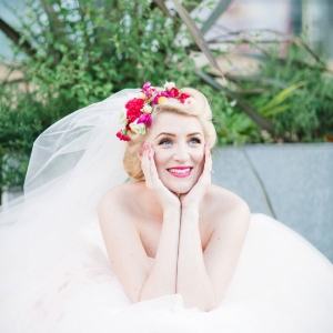 Carrie Bradshaw inspired bride wearing a pink & yellow floral crown and tulle veil