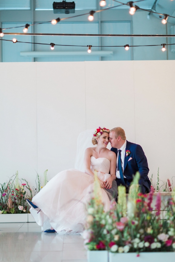 Art gallery and city park wedding with festoon lighting and an indoor flower meadow
