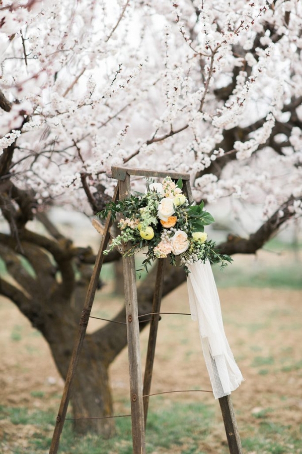 Beautiful wedding bouquet displayed on vintage wooden ladders