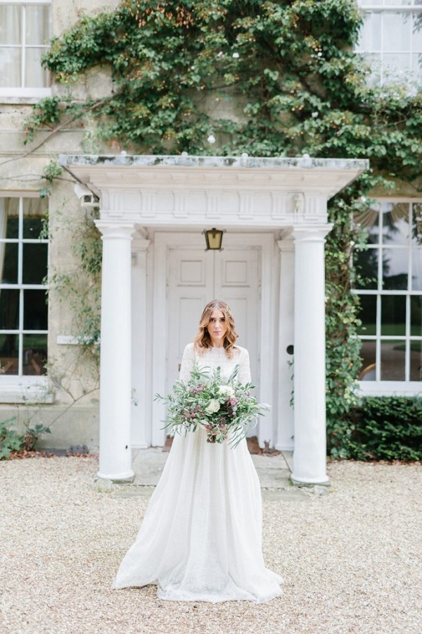bridal portrait stood in the grand doorway of the manor house