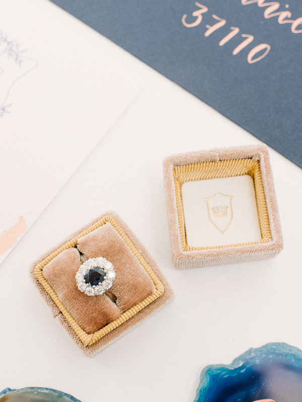Elegant velvet ring box with saphire engagement ring