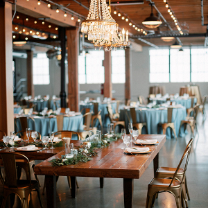 Modern industrial chic wedding reception tablescape inspiration with greenery and copper chairs