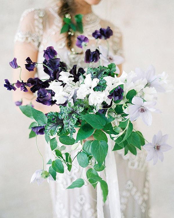 Fine art bridal bouquet of green ivy and deep purple florals