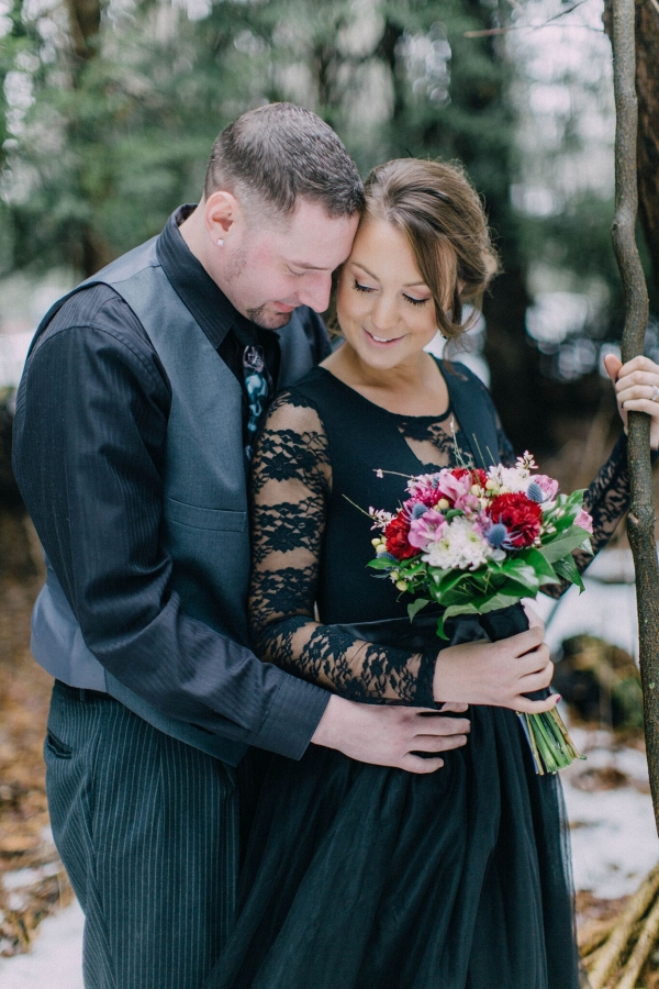 A Pop of Color from a Bouquet of Fresh Flowers was Bright against a Black Dress in this Twisted Fairy Tale Engagement Session
