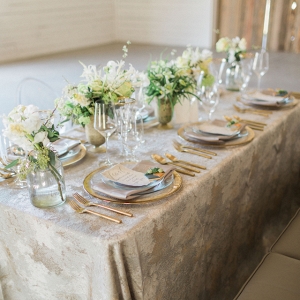 An elegant and rustic modern tablescape with a pewter and gold color palette. 