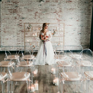 Vintage industrial wedding ceremony with ghost chairs