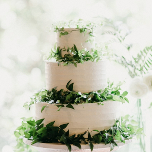 Classic white wedding cake with greenery