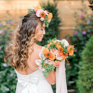 Bride with floral crown and orange bouquet