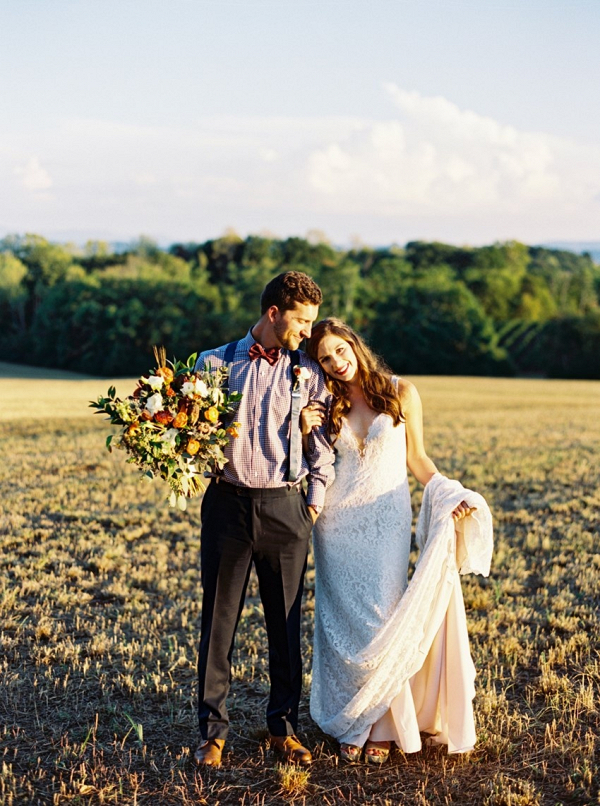 Couple in field with sunset glow on Chic Vintage Brides