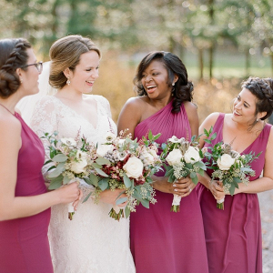 Bridesmaids in long berry dresses