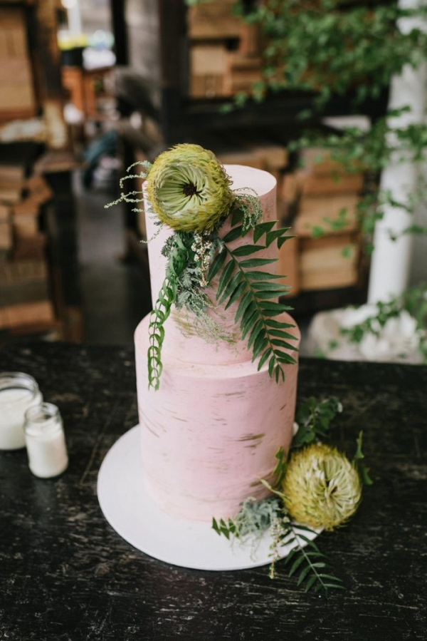 Pink wedding cake with greenery