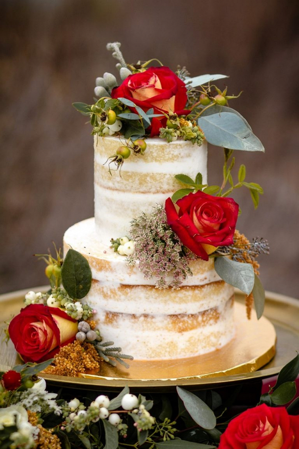 Semi naked wedding cake with red flowers