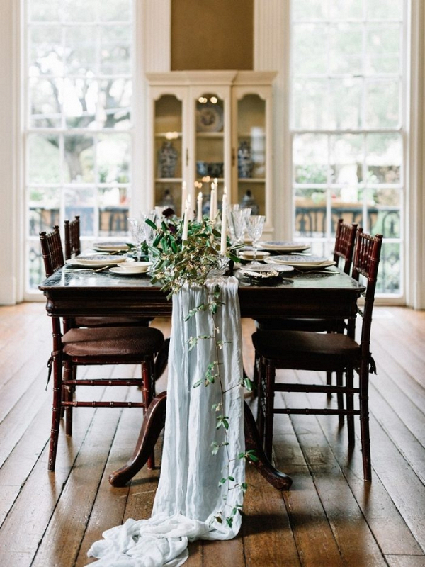 Wedding table with trailing table runner and greenery
