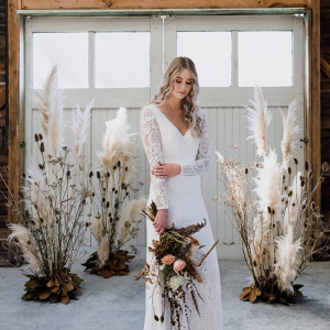 Fall bride with pampas grass ceremony backdrop