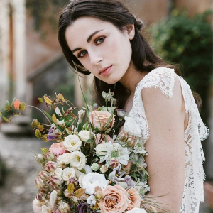 Vintage bride with lush and wild bouquet