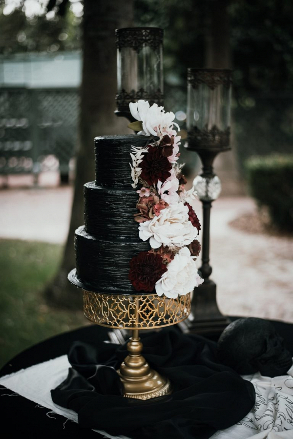 Black wedding cake with burgundy florals